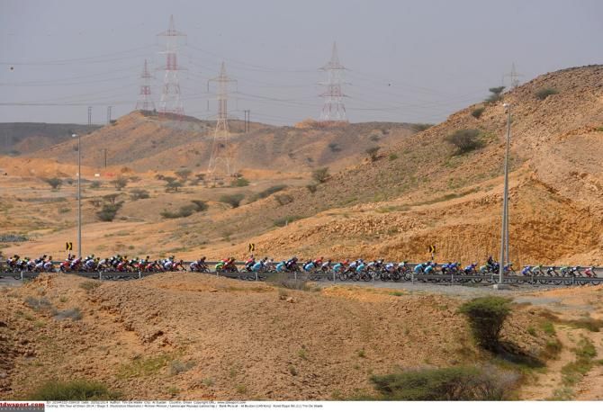 The Tour of Oman peloton rolls along during stage 3 from Bank Muscat to Al Bustan