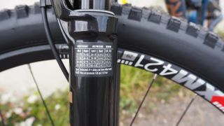 Close up of a MTB fork stanchion showing the setup sticker