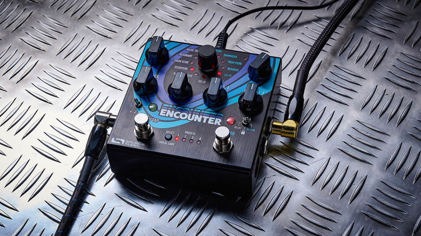The Source Audio Encounter delay and reverb pedal is photographed here in close-up against an industrial metal background.