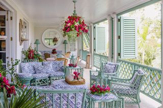 Green wooden seating and shutters, blue and white cushions