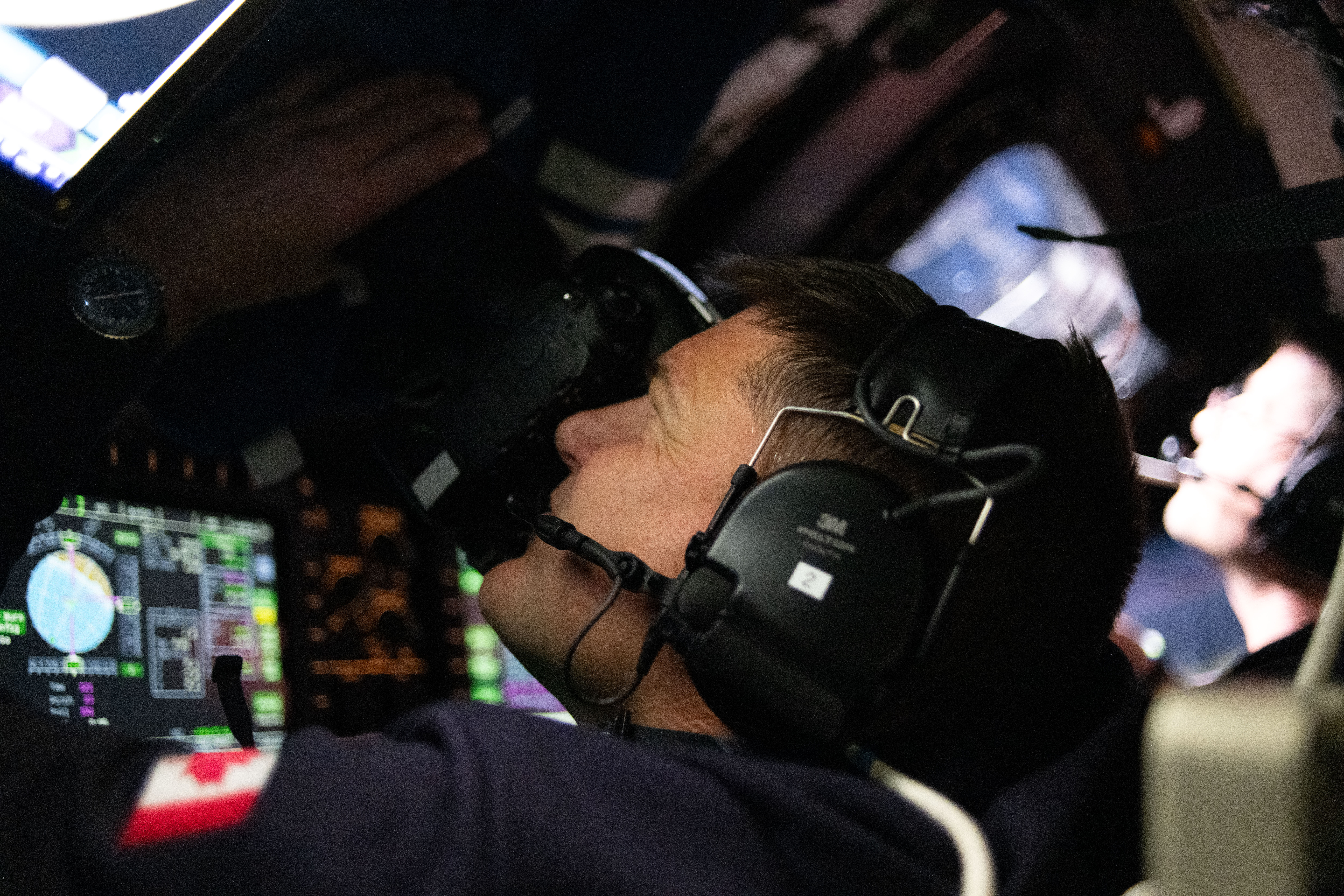 Artemis II Mission Specialist Jeremy Hansen takes photos from the Orion spacecraft window