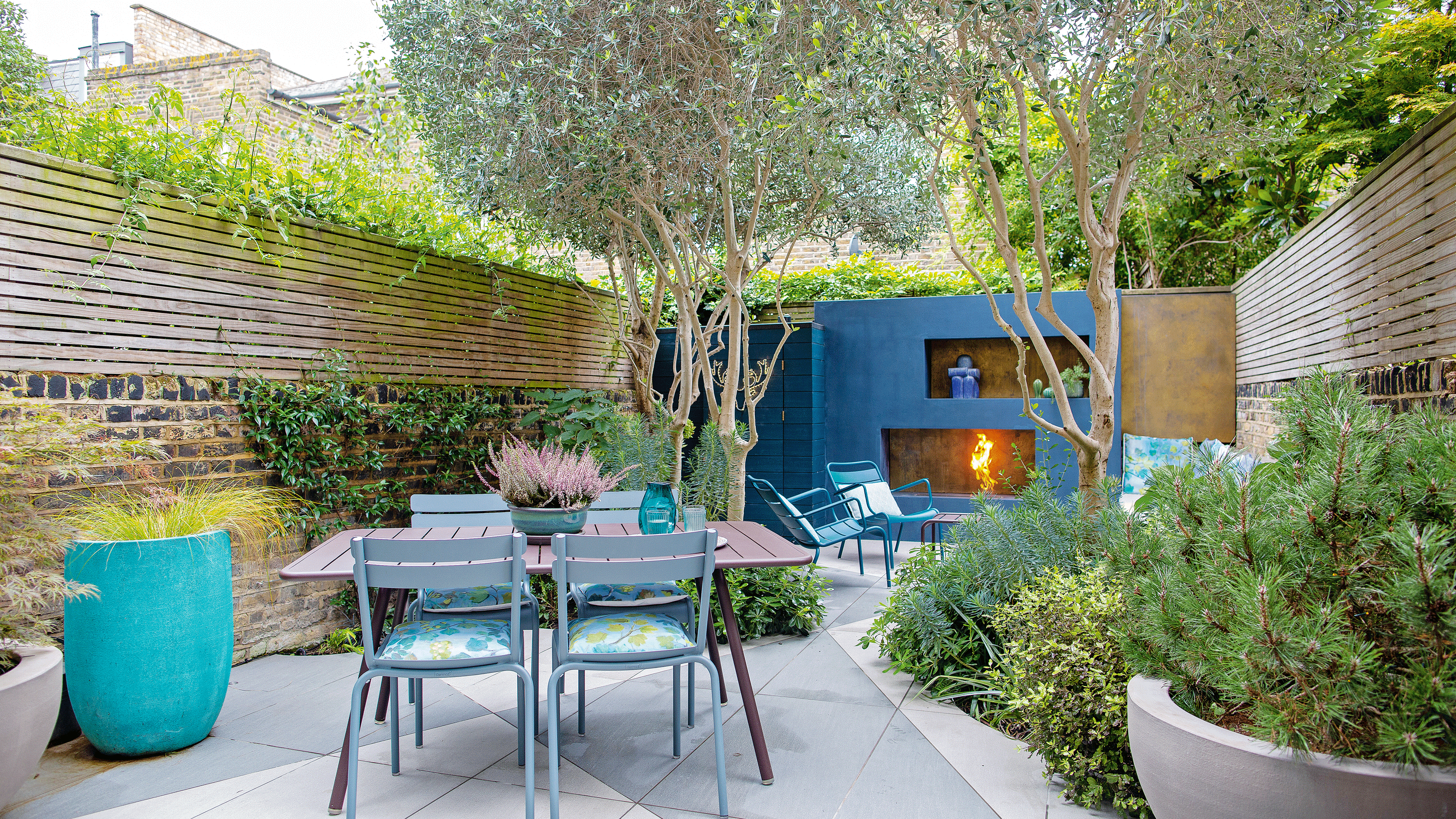 Patio with blue fire place and metal furniture