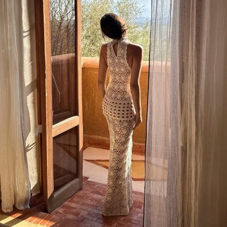 Elie wears a crochet dress.