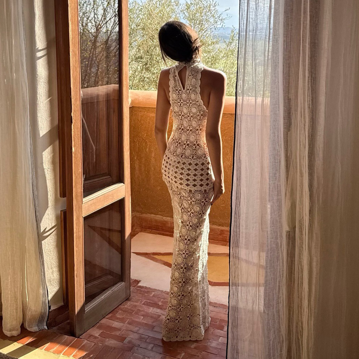 Elie wears a crochet dress.