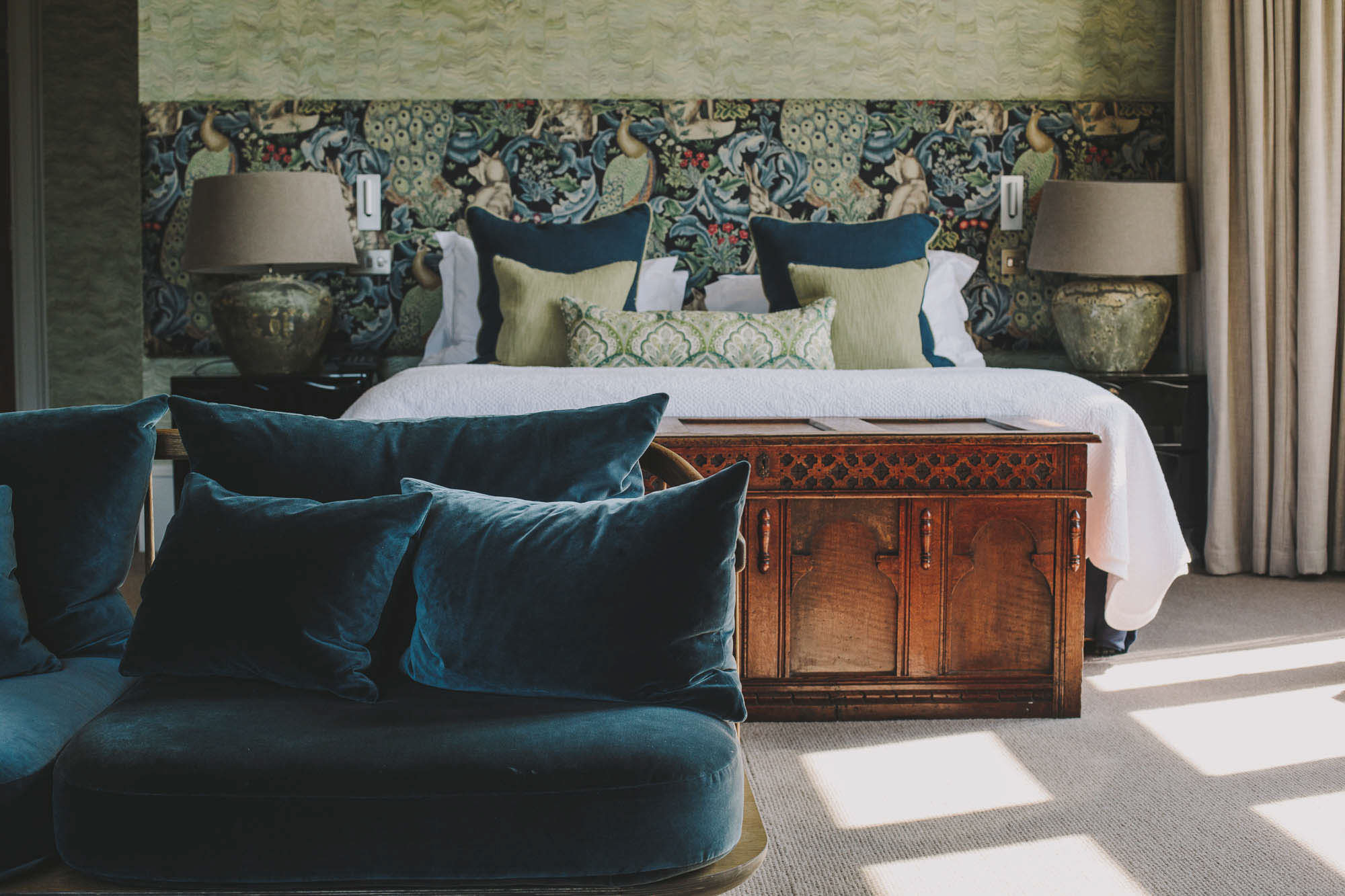 Vibrantly decorated hotel rooms feature plush textiles, eye-catching fabrics, and natural light.