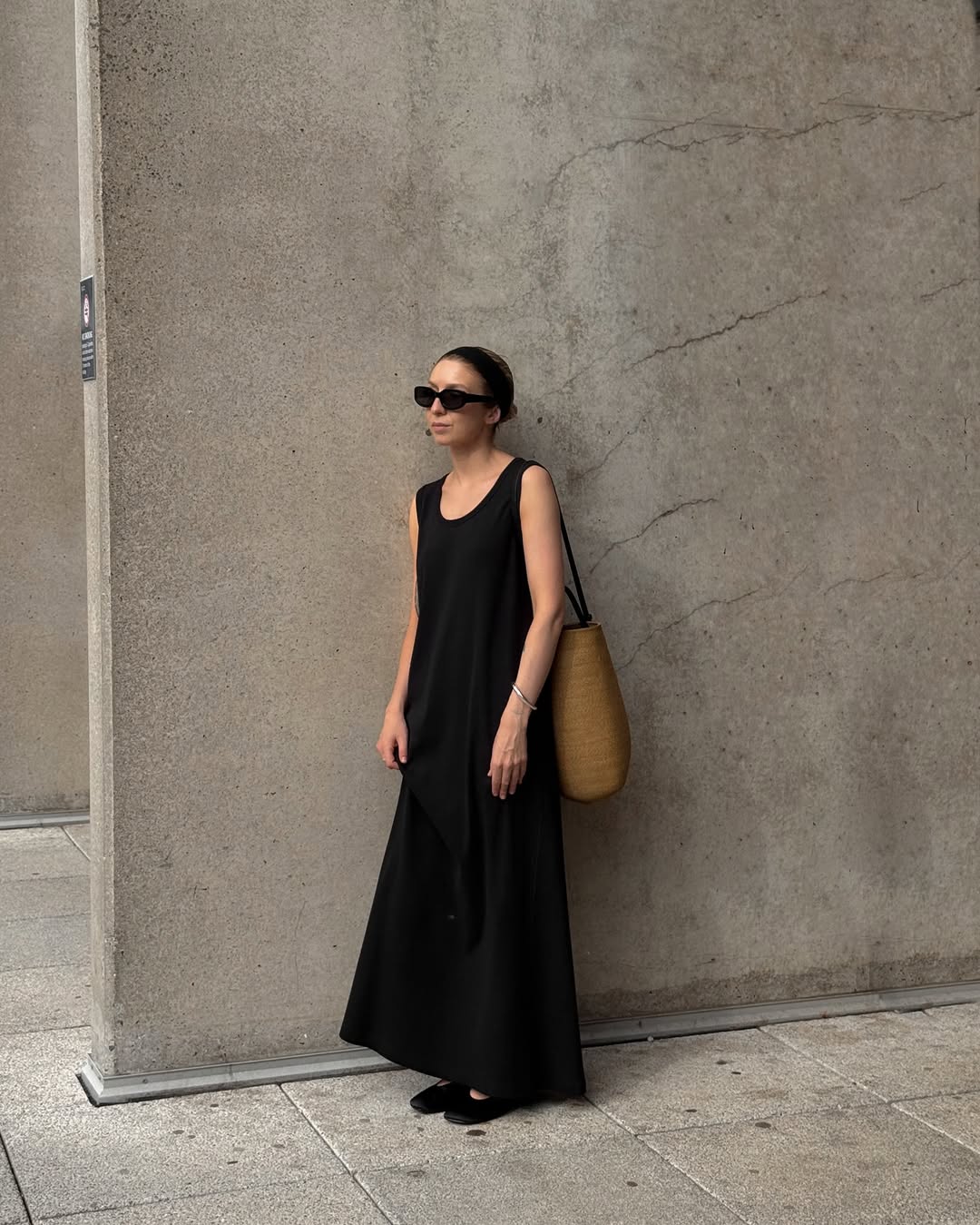@brittanybathgate wears. a black maxi dress, ballet flats, basket bag and sunglasses