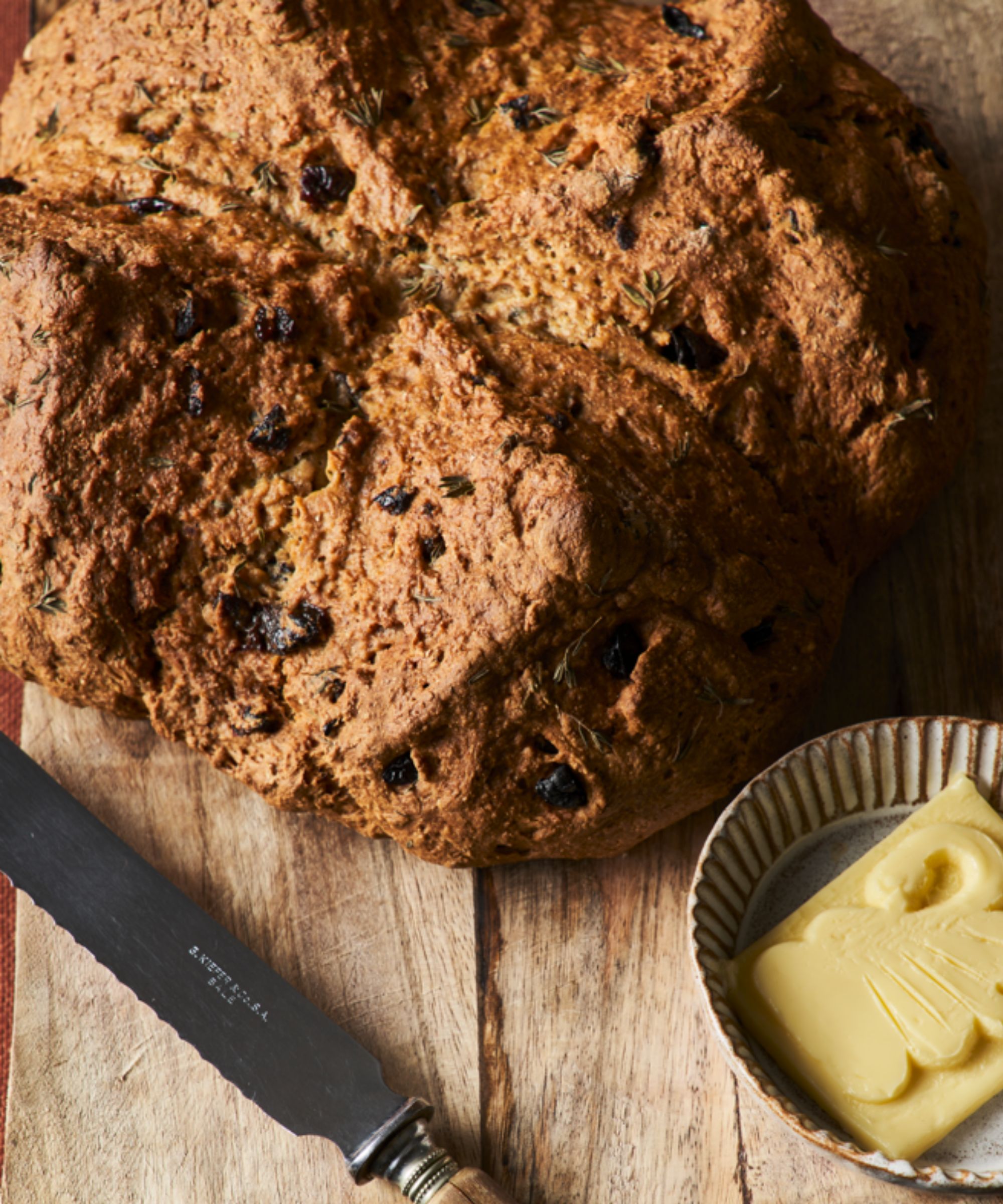 Bread loaf with knife and slab of butter