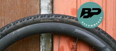 Pirelli Cinturato RC gravel tire fitted to a bike wheel and leaning against a wooden door with a Bike Perfect Recommends badge