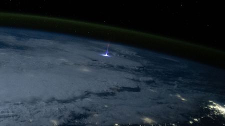 A photo from space showing a giant jet of blue light shooting above a thunderstorm