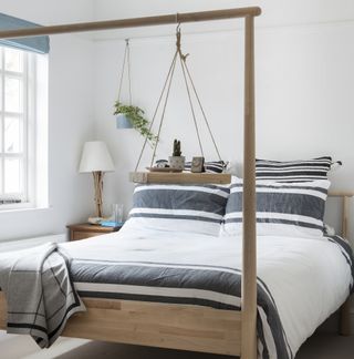 White bedroom with wooden bed frame
