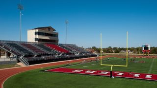 A high school football stadium view from the end zone.