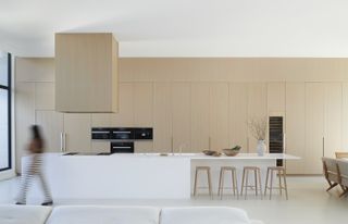 A kitchen with a seamless cabinet design