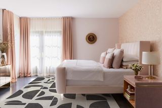 pink bedroom with printed area rug by Ruggable