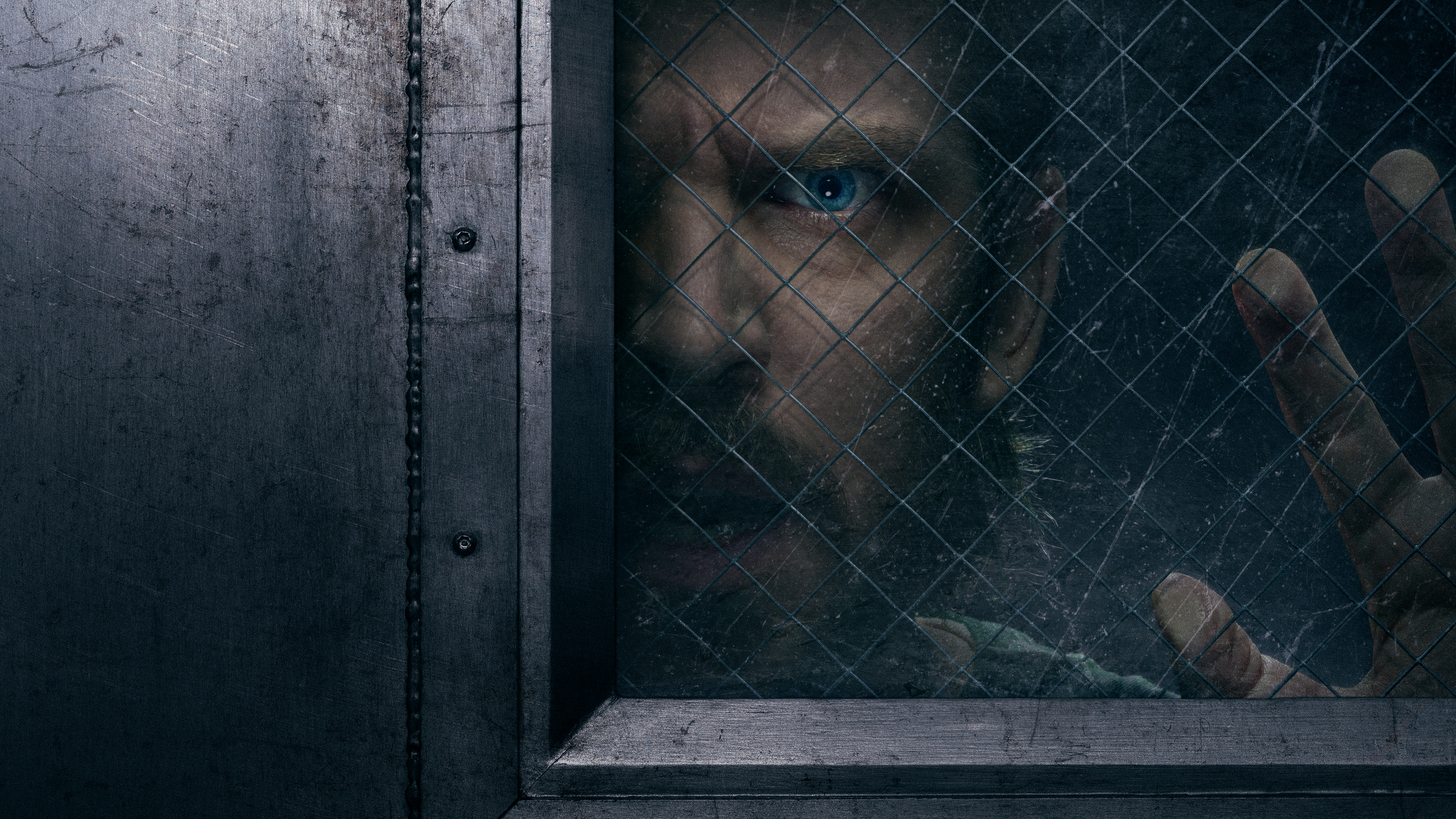 The Terror: Devil in Silver key art. Dan Stevens as Pepper with his face and hand against the glass of a cell door trying to get out.