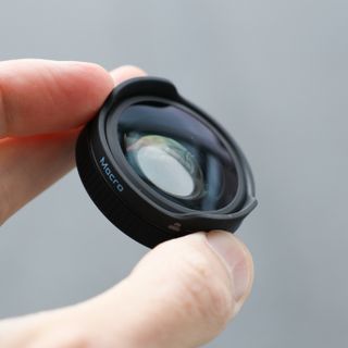 GoPro Macro Lens Mod held between a person's fingers