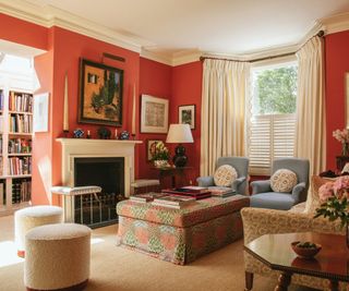 Olivia Dickinson living room with a fireplace, ottoman and pouffes