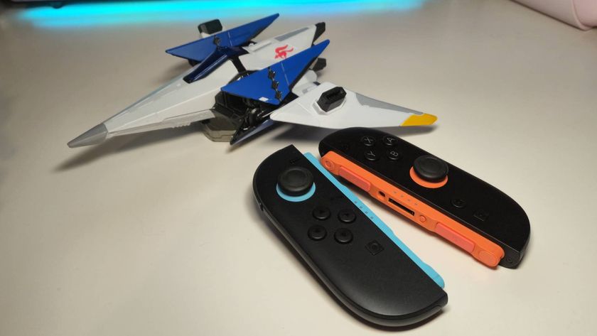 Photo of a pair of Switch 2 Joy-Con sitting next to a toy of a Star Fox Arwing.