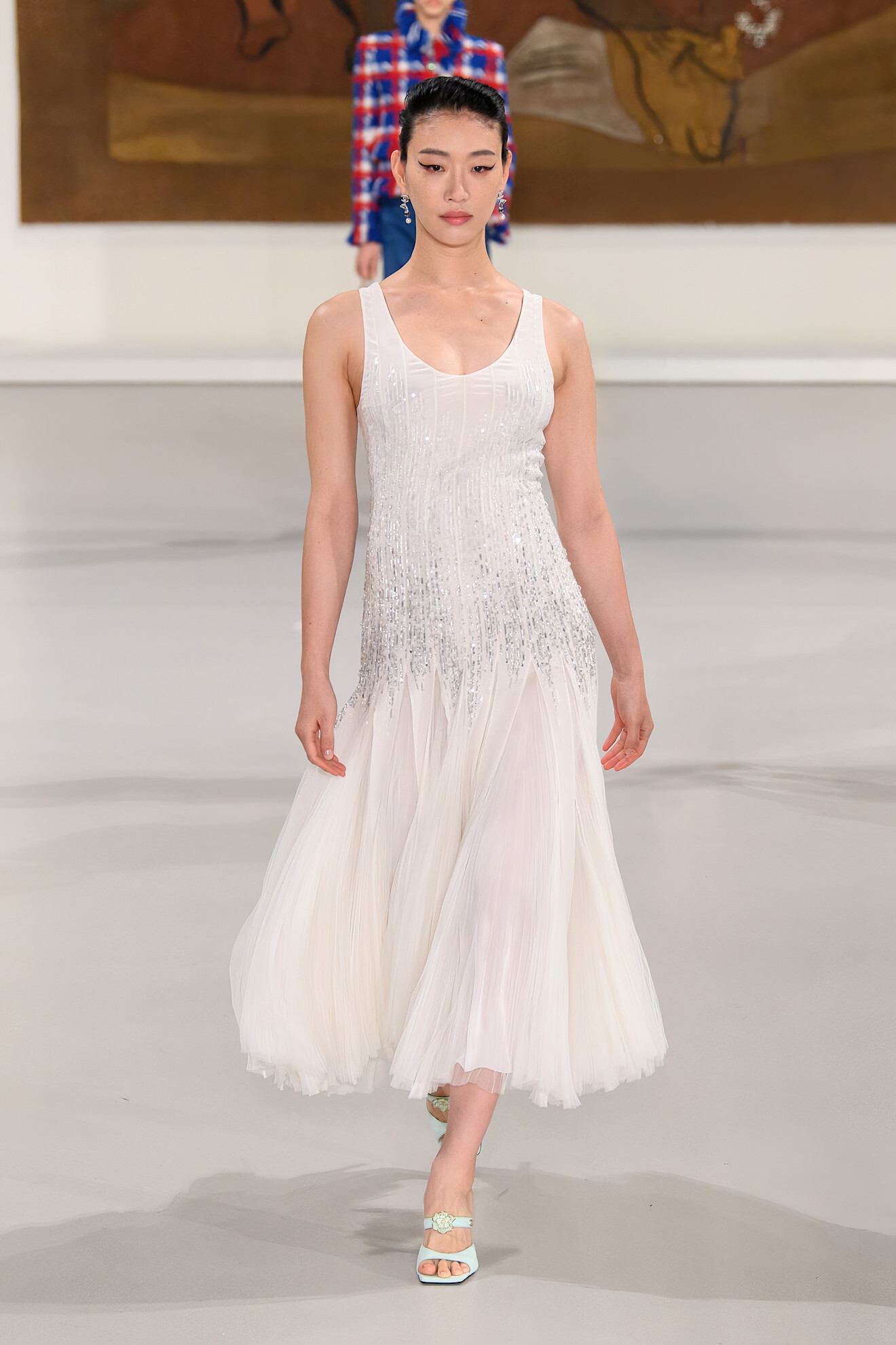 a model walks the Chanel runway while pregnant