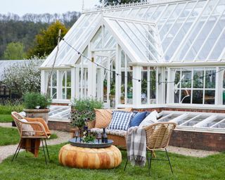 large greenhouse with seating area outside