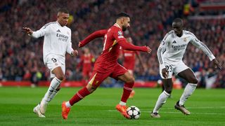 Mohamed Salah of Liverpool FC competes for the ball with Ferland Mendy of Real Madrid CF during the UEFA Champions League 2024/25 League Phase MD5 match between Liverpool FC and Real Madrid CF at Anfield on November 27, 2024 in Liverpool, England.