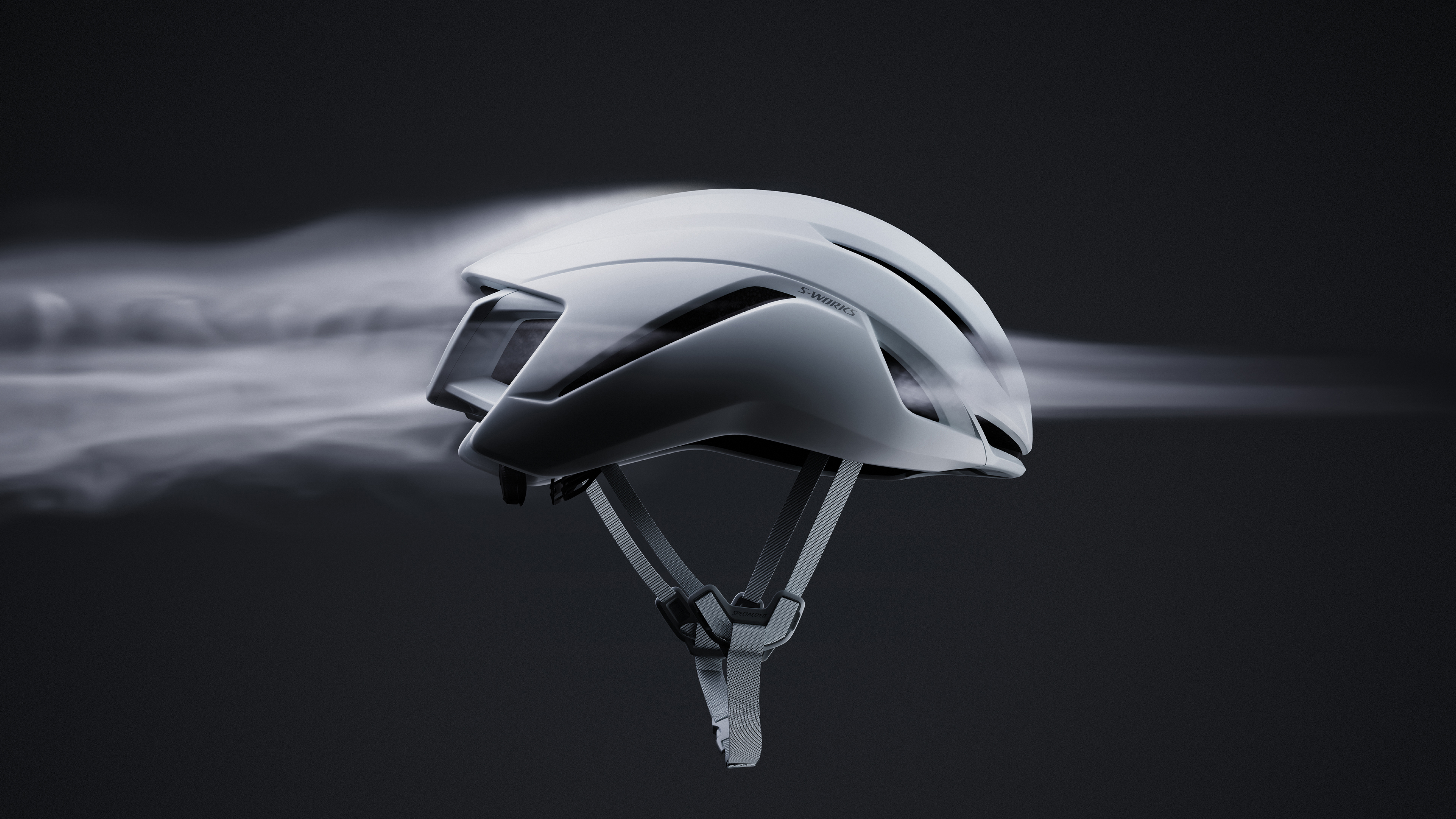The Specialized S-Works Evade 4, with fog flowing through its vents from front to back of the helmet to depict its new 2.4% increase in ventilation improvement. 