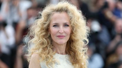 Image of Gillian Anderson smiling with voluminous blonde corkscrew hair