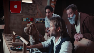 three sci-fi spoof characters and a dog in a cardboard spaceship