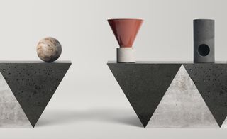 Three sculptures on top of triangular shaped stone