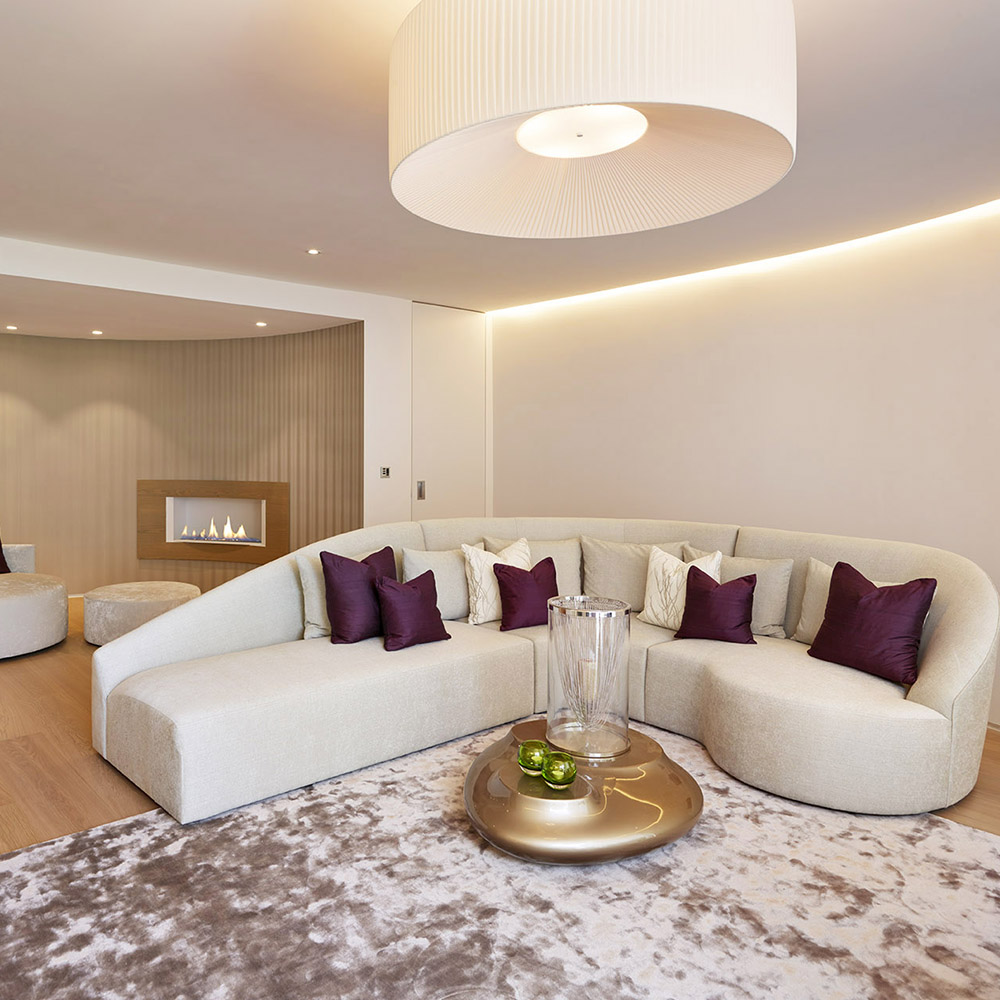 lounge with white wall and sofa with cushions and ceiling light