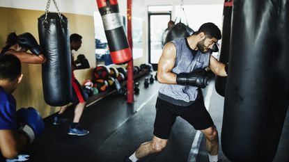 best punch bag: pictured here, a group of people practice heavy bag boxing in a gym