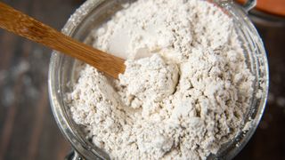 Diatomaceous earth in a container with a spoon