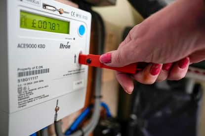Person putting key into prepay electricity meter
