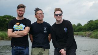 The Denkiworks developers stand in front of a lake
