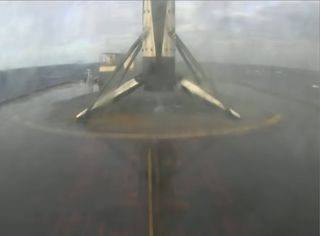 SpaceX's most-flown Falcon 9 rocket booster is seen atop the drone ship "Just Read The Instructions" after a successful landing, its 8th, following the launch of 60 Starlink satellites on Jan. 20, 2021.
