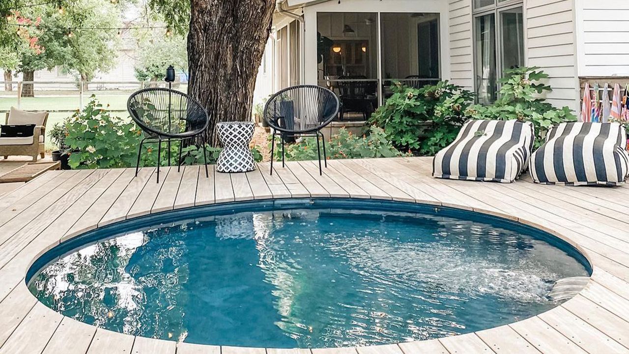 Above ground pool with decking, chairs and striped loungers