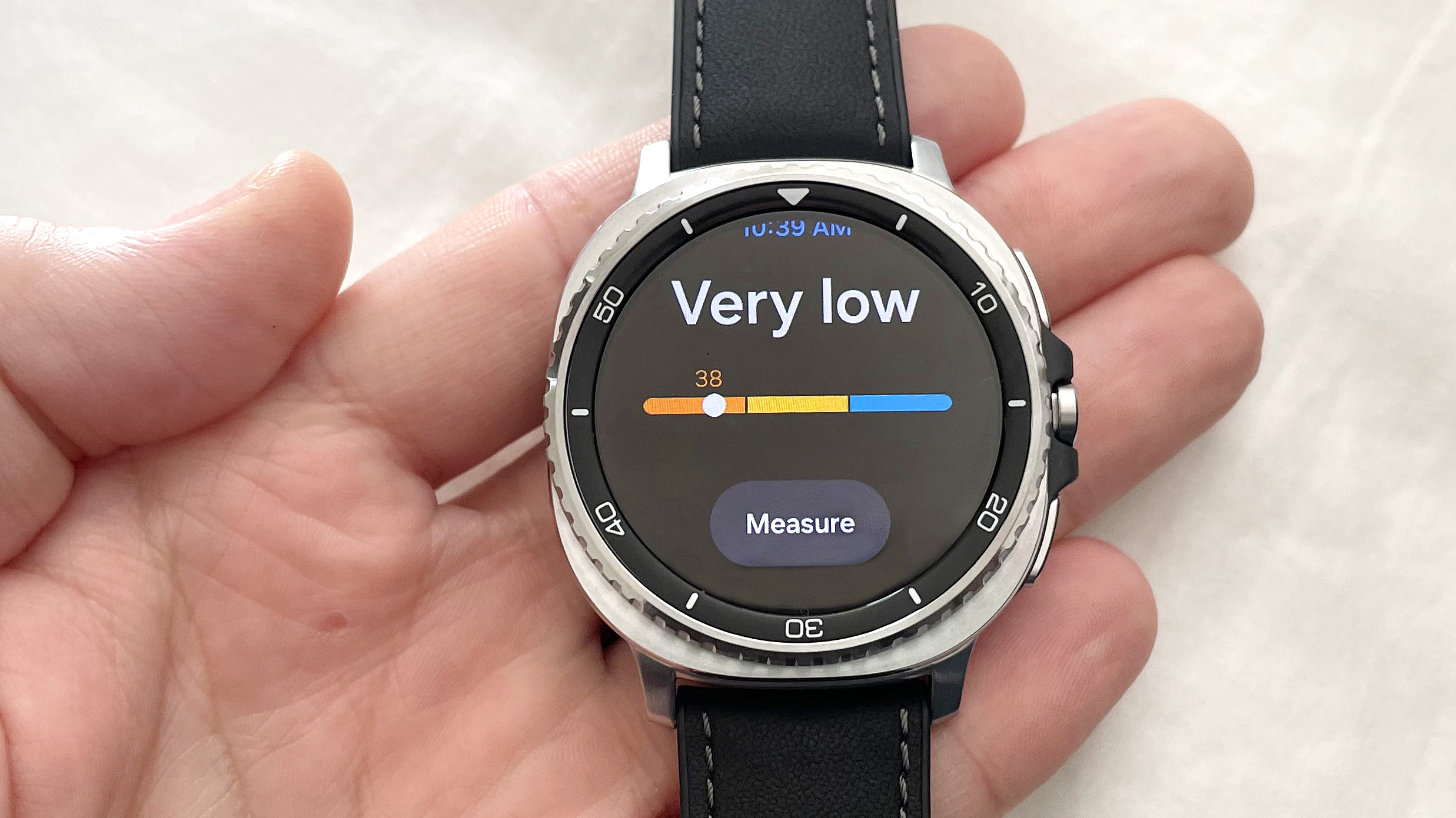 Close-up of the Samsung Galaxy Watch 8 Classic in silver on a black strap showing the Antioxidant testing feature with a rating of 