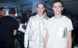 Two males modelling white shiny tops
