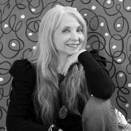 Black and white image of a woman wearing a long-sleeve black shirt and jeans.