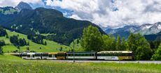 Panoramic train of the MOB Montreux-Oberland Bernois railway on the GoldenPass line close to Gstaad, Switzerland