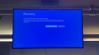 An airport screen showing the blue screen of death