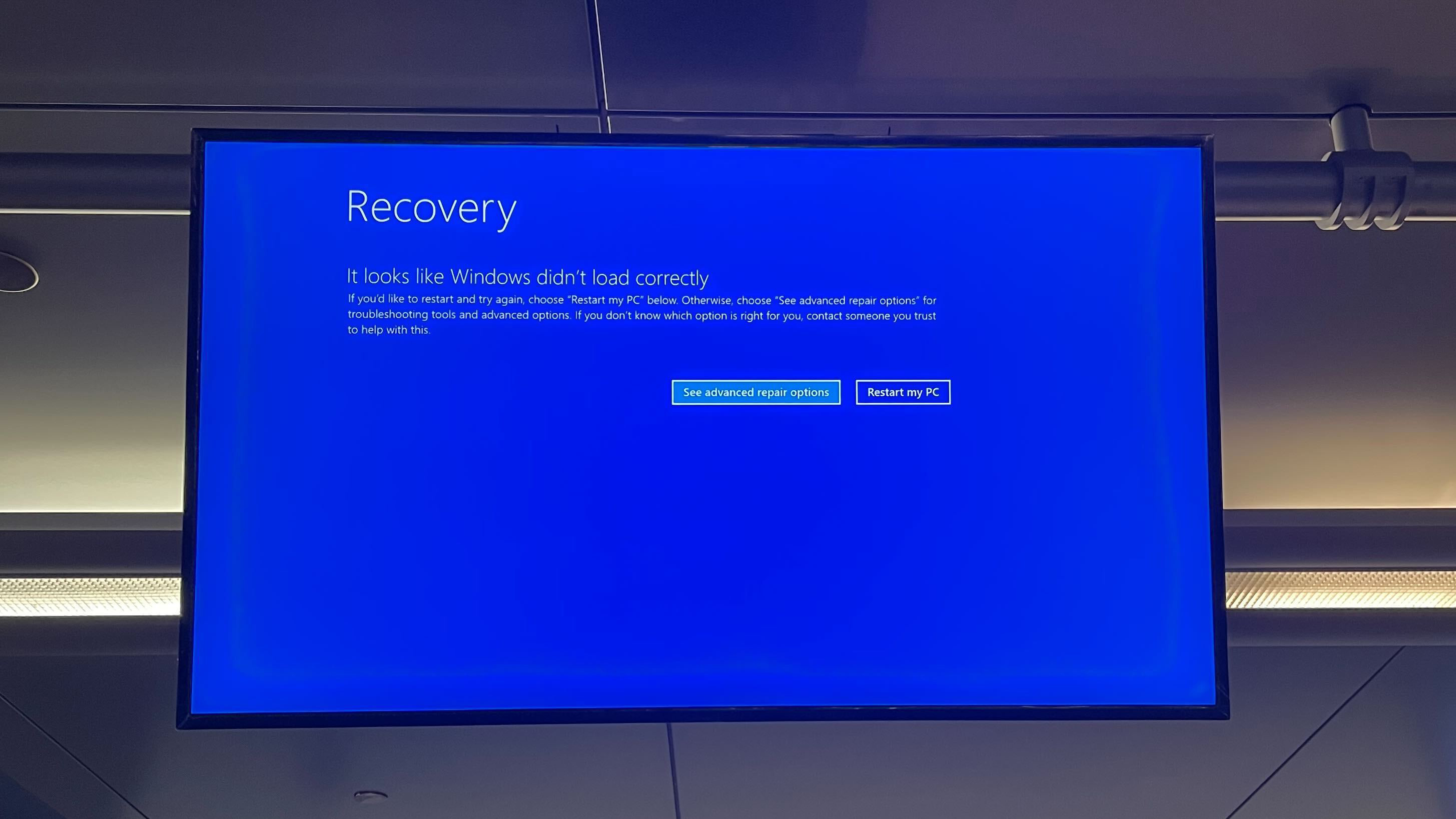 An airport screen showing the blue screen of death