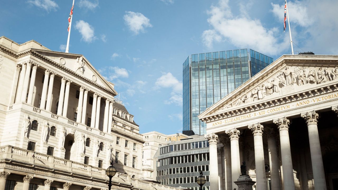 bank of england in london with glass office building behind