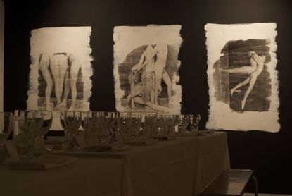 The table is set for the first in a series of dinners at The Cob Gallery in London, with a backdrop of works by artist Walter Hugo