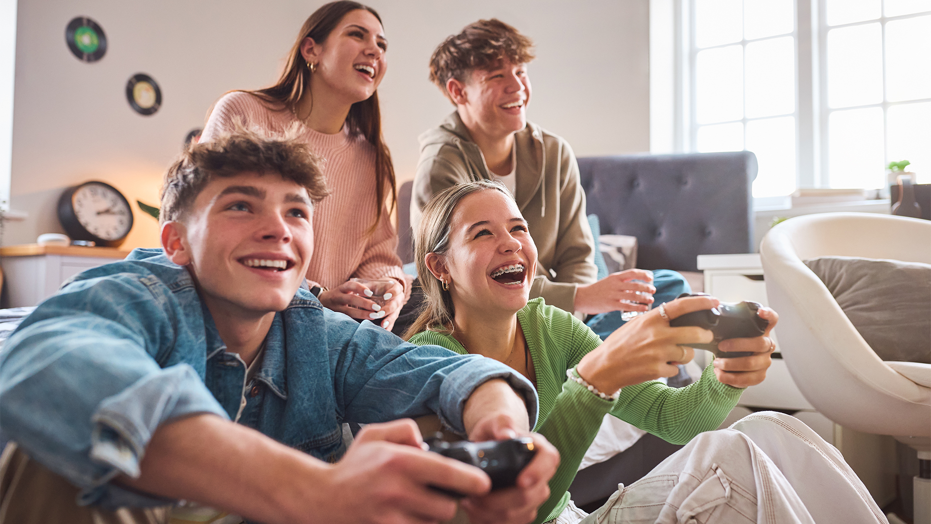 Close Up Of Teenage Girls And Boys At Home In Bedroom Together Playing Computer Games Together