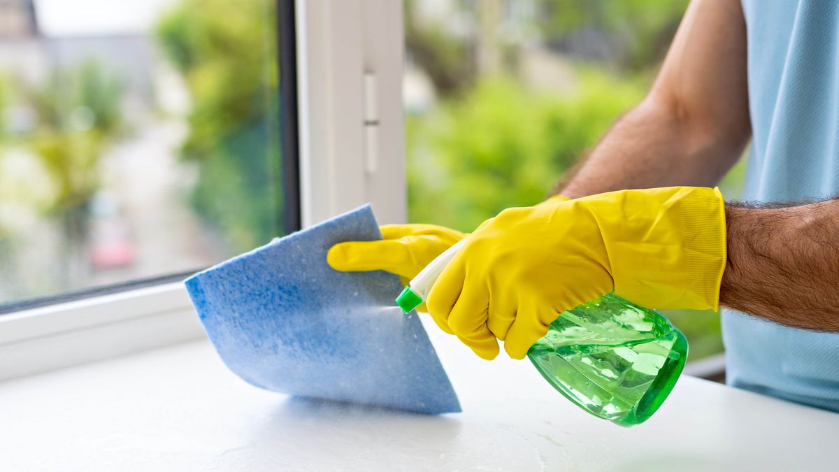 Spraying cleaner onto cloth