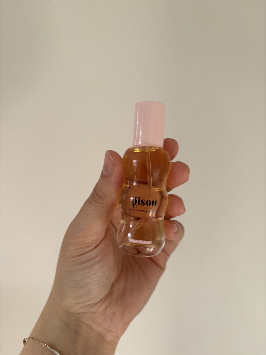 Mica Ricketts holding Gisou Honey Infused Hair Perfume