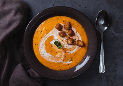 Roast sweet potato soup swirled with cream and topped with croutons