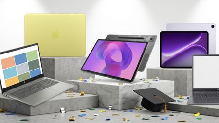 Selection of laptops and tablets on podiums, with confetti and a graduation cap