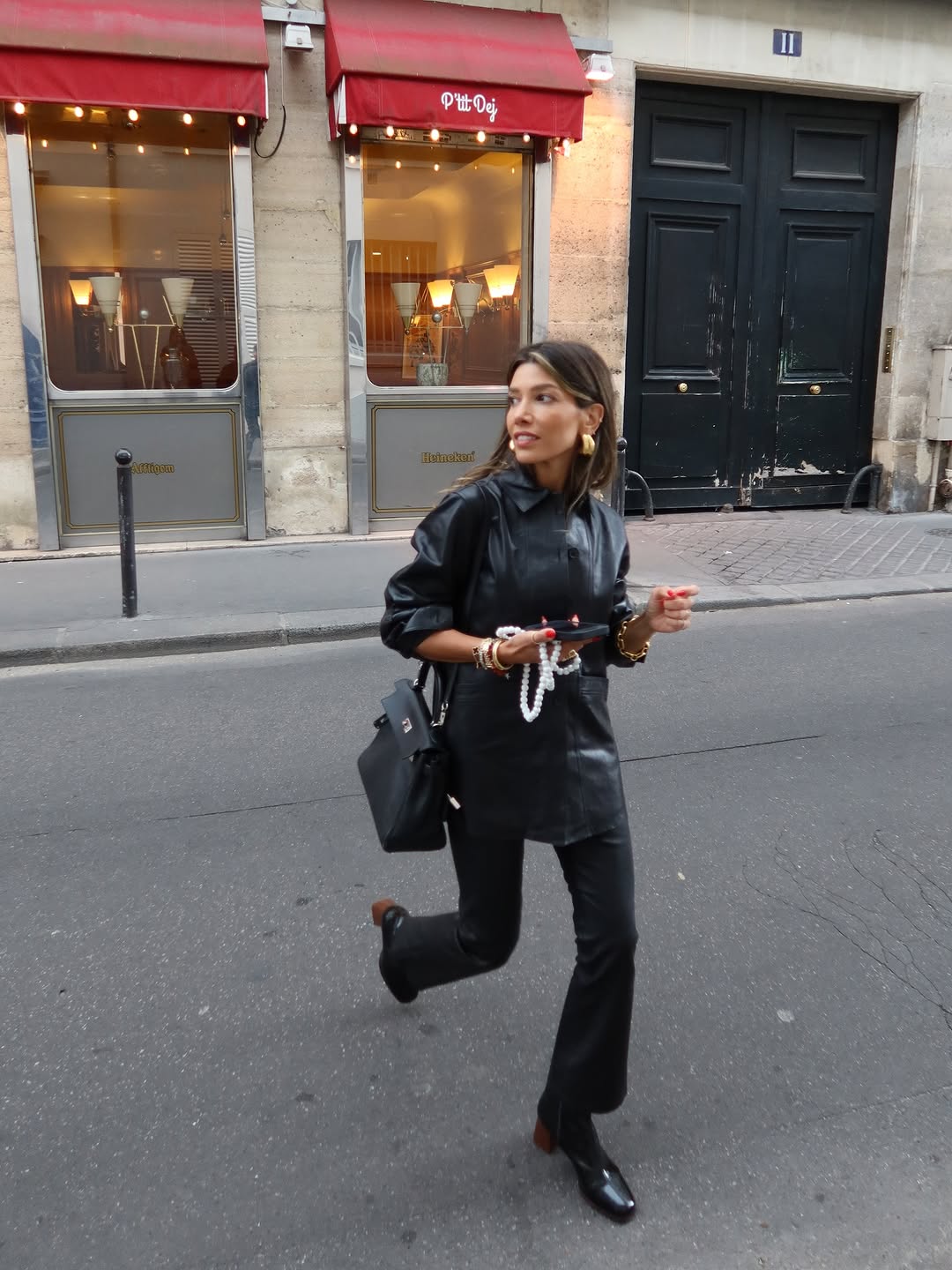 Woman wearing collared leather jacket trend fall 2025.