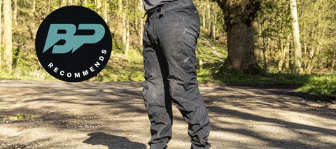 Man wearing Rapha Trail Gore-Tex pants with woods behind